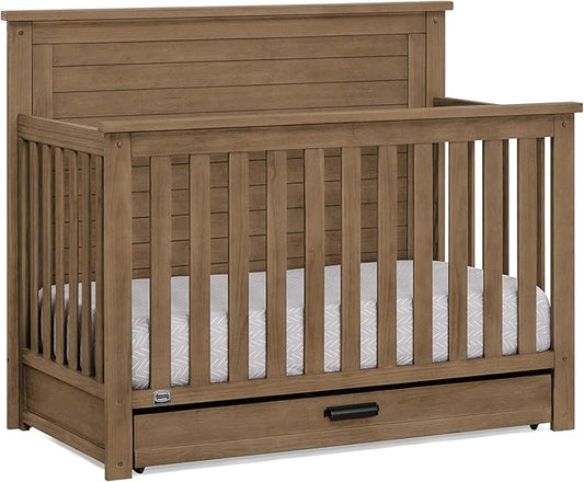 Delta Children Simmons Kids Caden 6-in-1 Convertible Crib with Trundle Drawer, Greenguard Gold Certified, Aged Oak