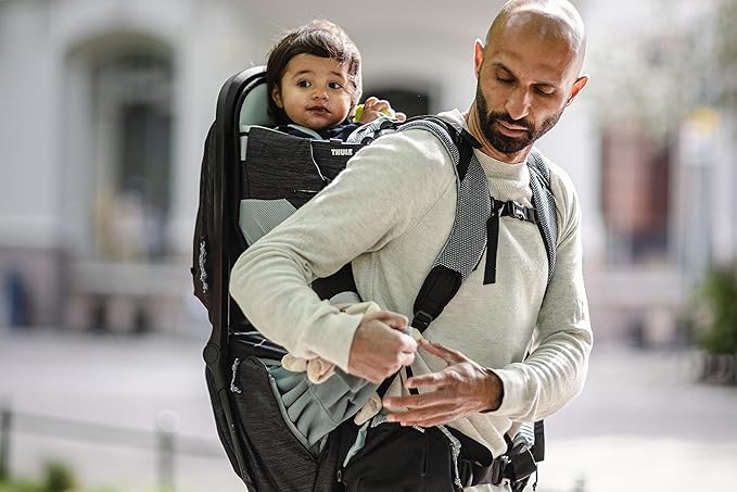 Thule Sapling Child Carrier Backpack - Machine Washable Seat - Self-Standing Frame - Adjustable padded straps for parents - Ergonomic seat with under-leg support for child - UPF 50 Sunshade